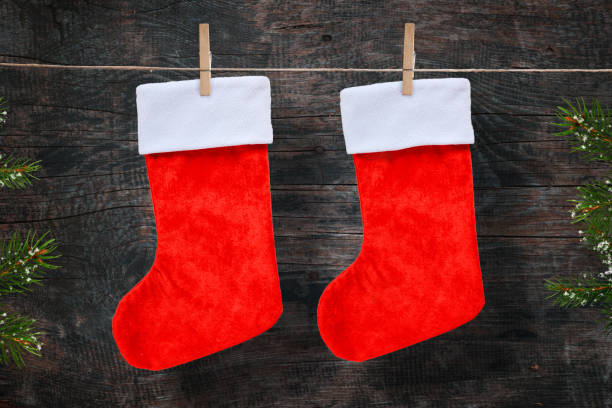istock Christmas red socks on rope. Wooden background. 1074215878