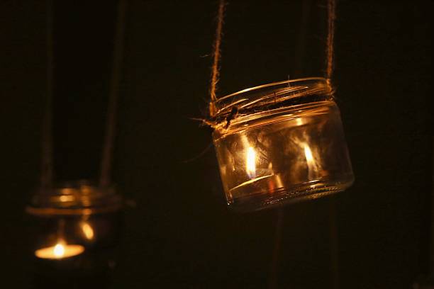 istock Aromatic candle in jar hanging indoor. 1074216940