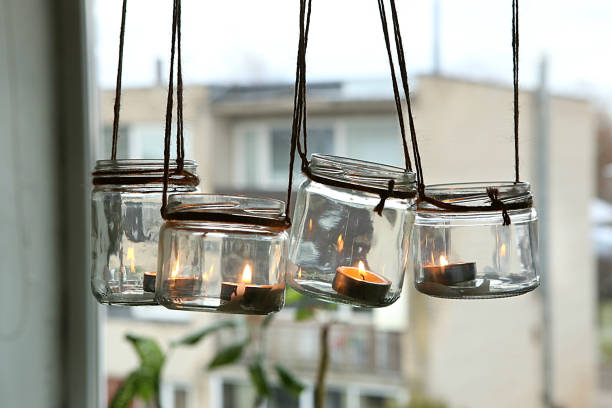 DIY candles in glass jars hanging on linen jute.
