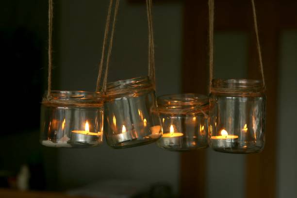 istock Aromatic candles in jars hanging in interior. 1074217356
