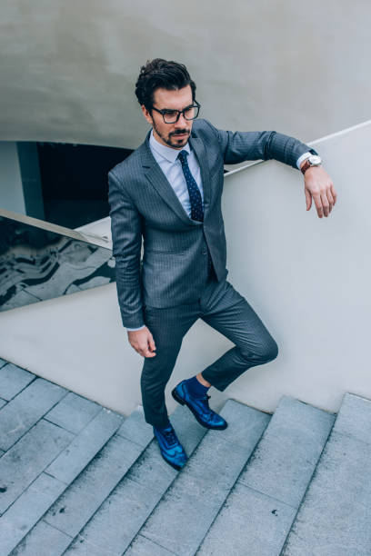 istock Bearded man standing on the stairs 1074219240
