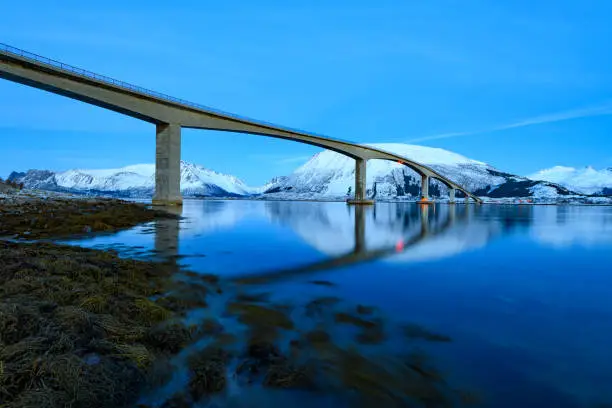 Gimsøystraumen Bridge in the Sydalspollen Fjord during sunset in the Lofoten in winter after a beautiful cold winter day in the North.