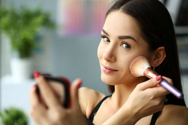 istock Young smiling beautiful brunette woman make her face up 1074222208