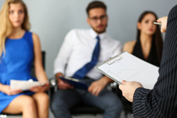 istock Group of people sit on casting chairs row at boss reception 1074222236