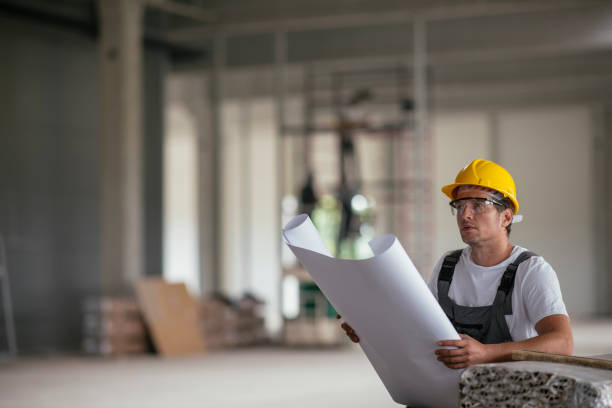 istock Handsome engineer in factory with blueprint 1074226172