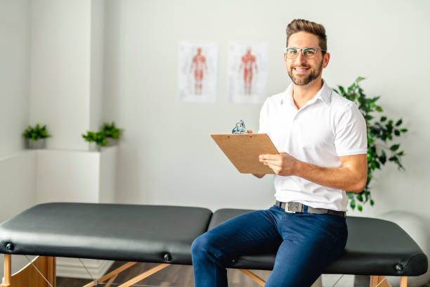 A Modern rehabilitation physiotherapy man at work Modern rehabilitation physiotherapy man at work physical therapist stock pictures, royalty-free photos & images