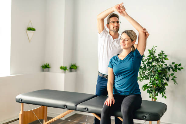 A Modern rehabilitation physiotherapy man at work with woman client Modern rehabilitation physiotherapy man at work biomechanics photos stock pictures, royalty-free photos & images