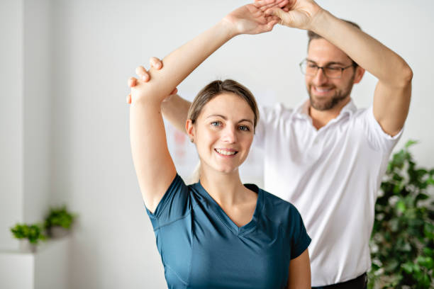 istock A Modern rehabilitation physiotherapy man at work with woman client 1074230824