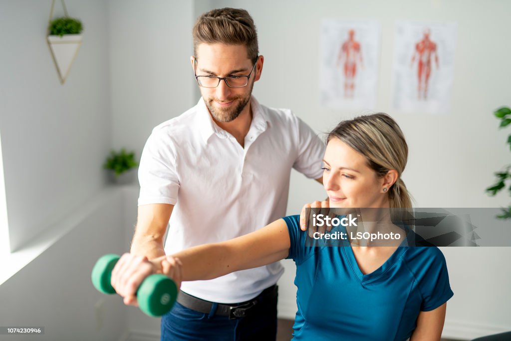 A Modern rehabilitation physiotherapy man at work with woman client Modern rehabilitation physiotherapy man at work Physical Therapy Stock Photo