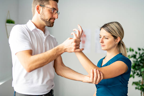 istock A Modern rehabilitation physiotherapy man at work with woman client 1074230974