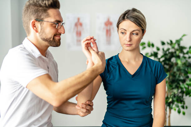 istock A Modern rehabilitation physiotherapy man at work with woman client 1074231044