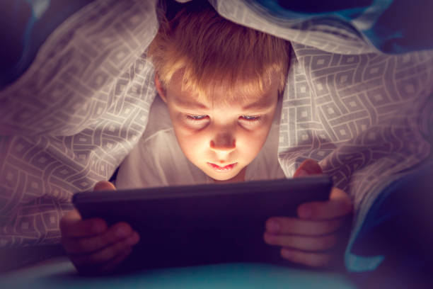 istock Boy watching a movie on a digital tablet 1074231064