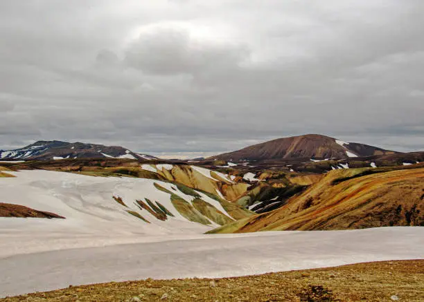 Photo of Colourful rhyolite mountains under snow, Laugavegur hiking trail, Fjallabak Nature Reserve, Highlands of Iceland, Europe