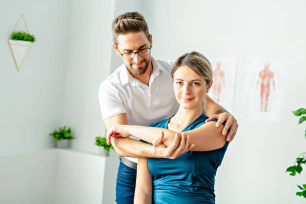 istock A Modern rehabilitation physiotherapy man at work with woman client 1074231500