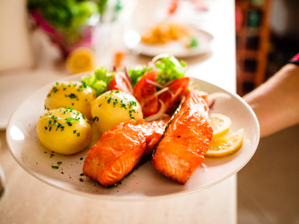 istock Fish dish - fried salmon with vegetables 1074231600