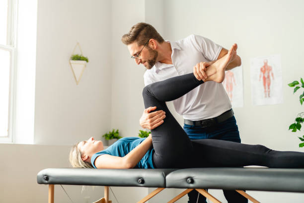 istock A Modern rehabilitation physiotherapy man at work with woman client working on leg 1074232070