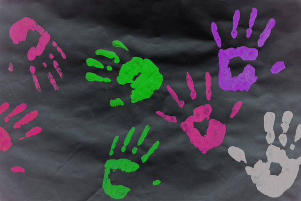istock Color prints of kid's hands on a white sheet 1074234694