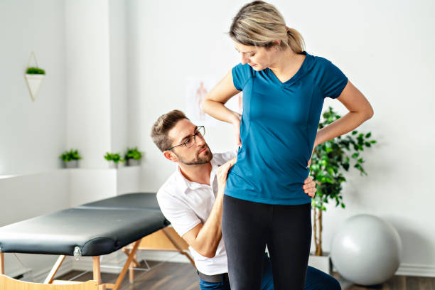 istock A Modern rehabilitation physiotherapy man at work with woman client working on hip 1074238948