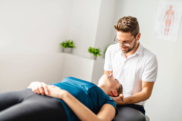 istock A Modern rehabilitation physiotherapy man at work with woman client working on neck 1074239078