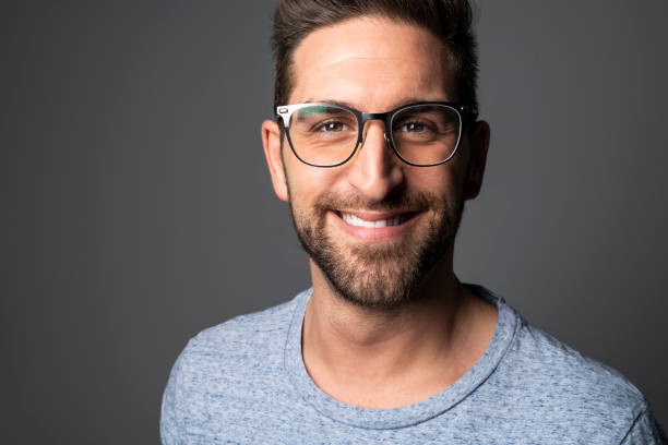 istock A Handsome man standing over dark grey background Portrait man concept. 1074239398