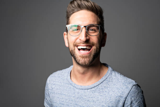 istock A Handsome man standing over dark grey background Portrait man concept. 1074239440