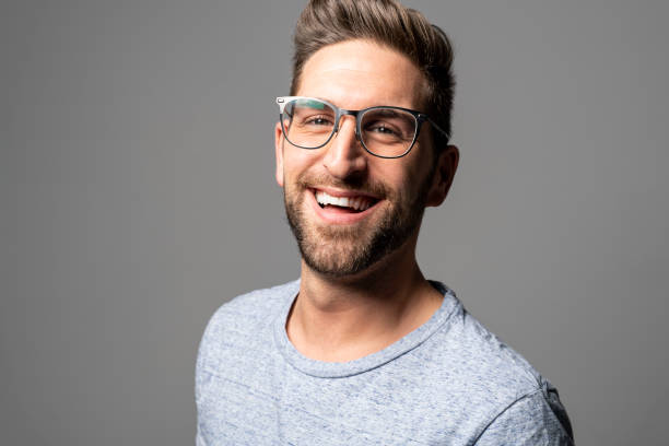 istock A Handsome man standing over dark grey background Portrait man concept. 1074239476