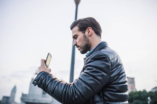 istock Young man photographing with phone 1074239638
