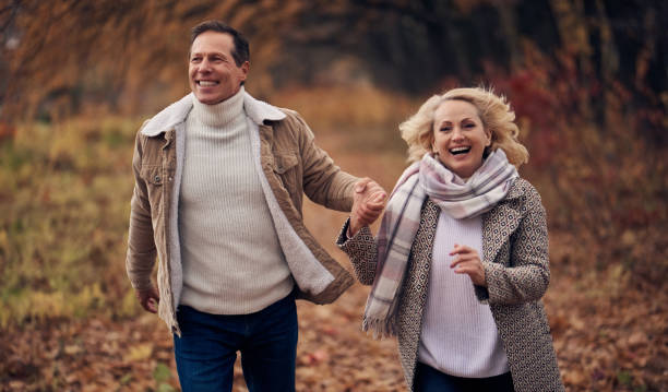 istock Senior couple in park in autumn 1074240670