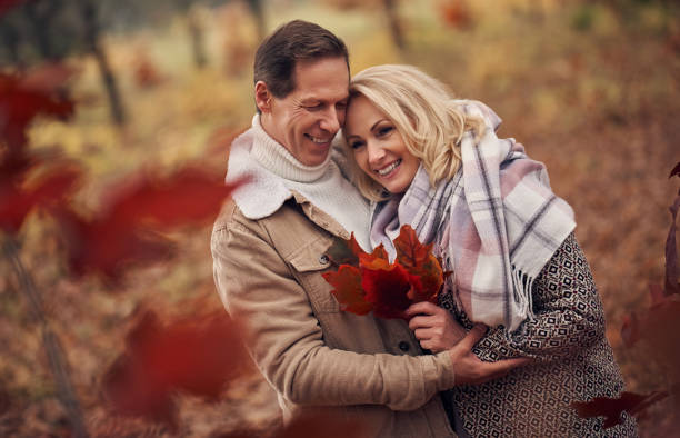 istock Senior couple in park in autumn 1074241274