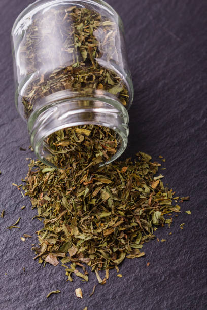 istock dried tarragon and essential oil on a dark stone background 1074241948