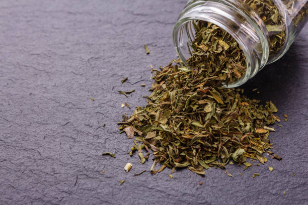 istock dried tarragon and essential oil on a dark stone background 1074241950