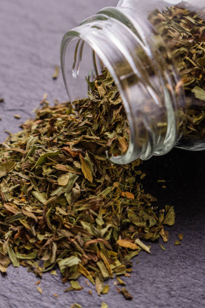 istock dried tarragon and essential oil on a dark stone background 1074241960