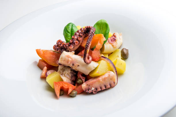 istock Dish with salad of octopus potatoes capers tomato and basil 1074242194