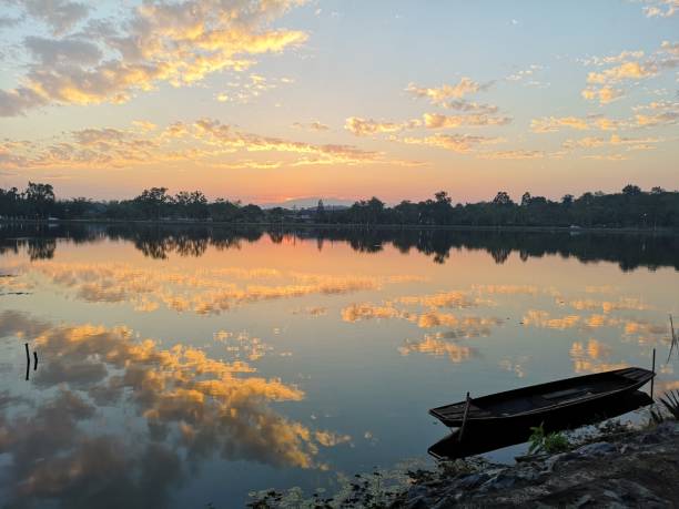 istock wood boat on the river and sky clouds sunset 1074243708