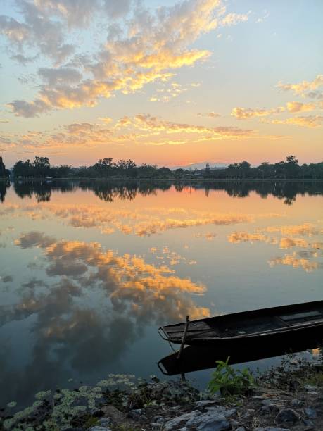 istock wood boat on the river and sky clouds sunset 1074243830
