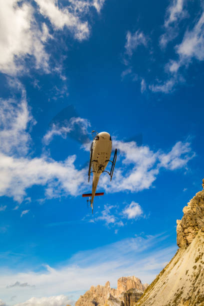istock Helicopter used for rescue operations also for bringing construction materials, on the ground Tre Cime di Lavaredo in Dolomites, Italy. 1074245402