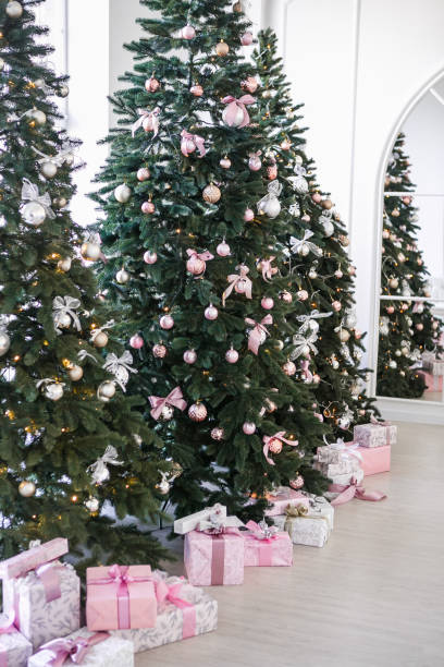 istock various gifts under beautiful Christmas trees 1074245938