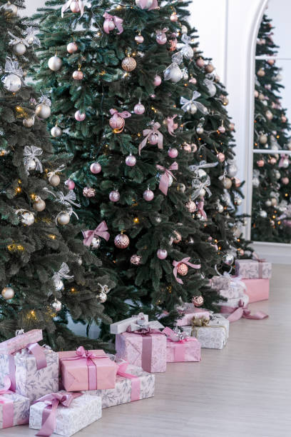 istock various gifts under beautiful Christmas trees 1074246032