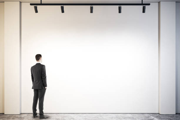 istock Businessman looking at poster 1074246458