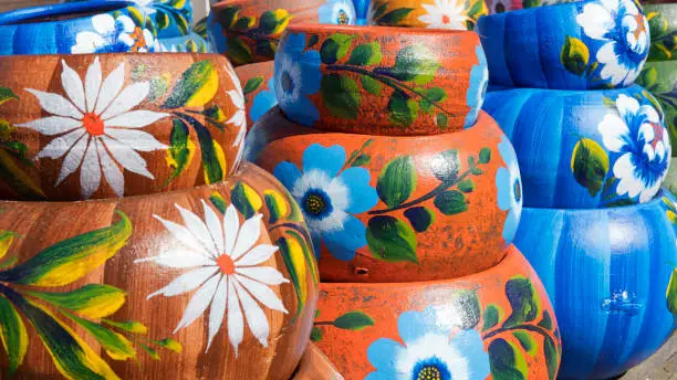 Photo of Close up on sets of colorful hand painted Mexican ceramic pots