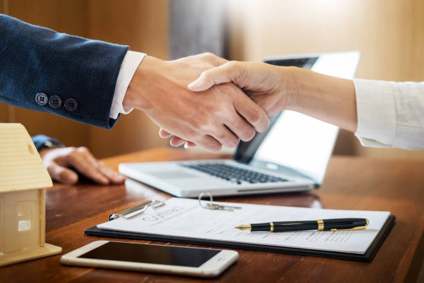 istock Cropped Image Of Colleagues Shaking Hands In Office 1074257486