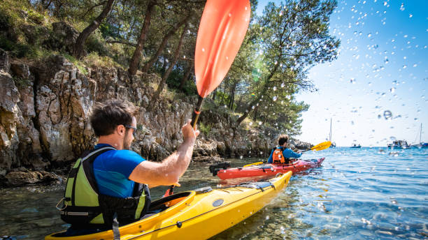 istock Kayakers rowing together in sea 1074257570