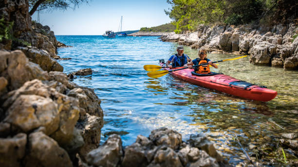 istock Mature man and woman kayaking 1074257572