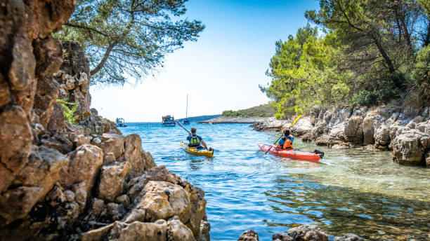 istock Kayakers rowing together in sea 1074257576