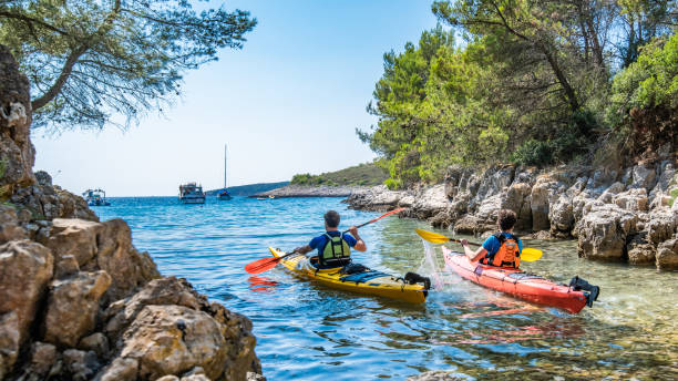 istock Kayakers rowing together in sea 1074257584