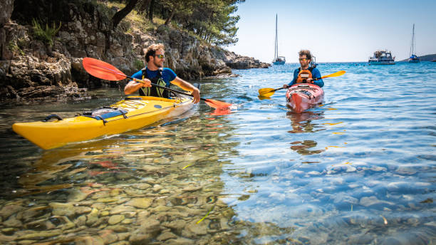 istock Kayakers rowing together in sea 1074257588