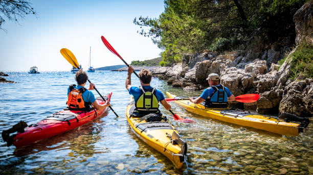 istock Kayakers rowing together in sea 1074257598