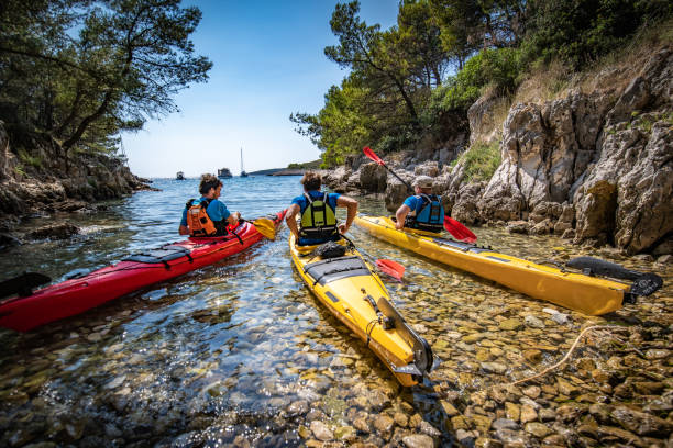 istock Kayakers rowing together in sea 1074257610
