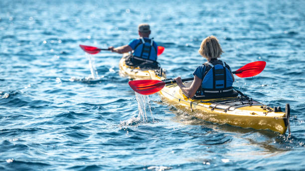 istock Kayakers rowing together in sea 1074257614