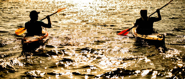 istock Kayakers rowing together in sea 1074257620